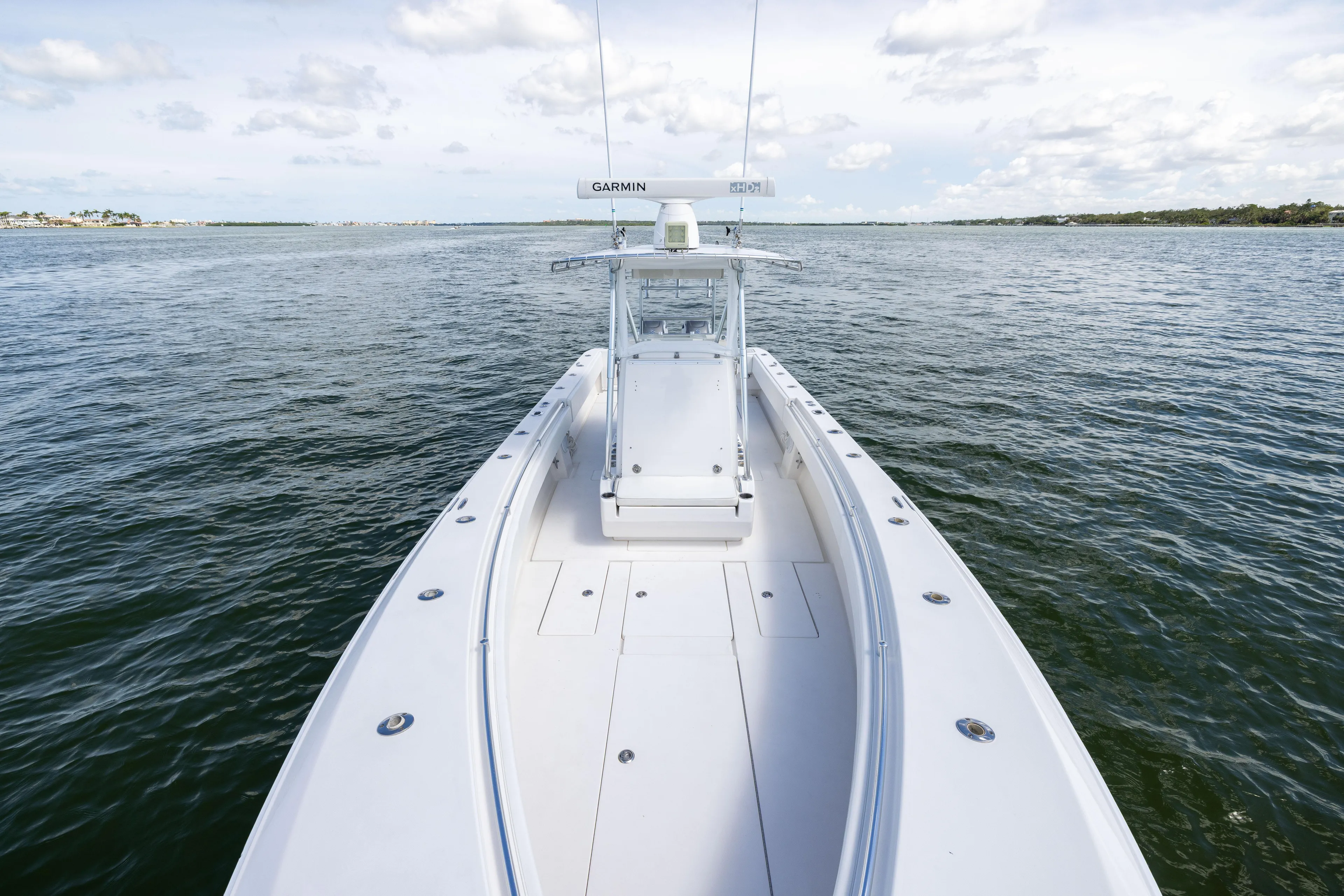  Yacht Photos Pics 2008 Contender 31 Open boat on calm water under a partly cloudy sky.