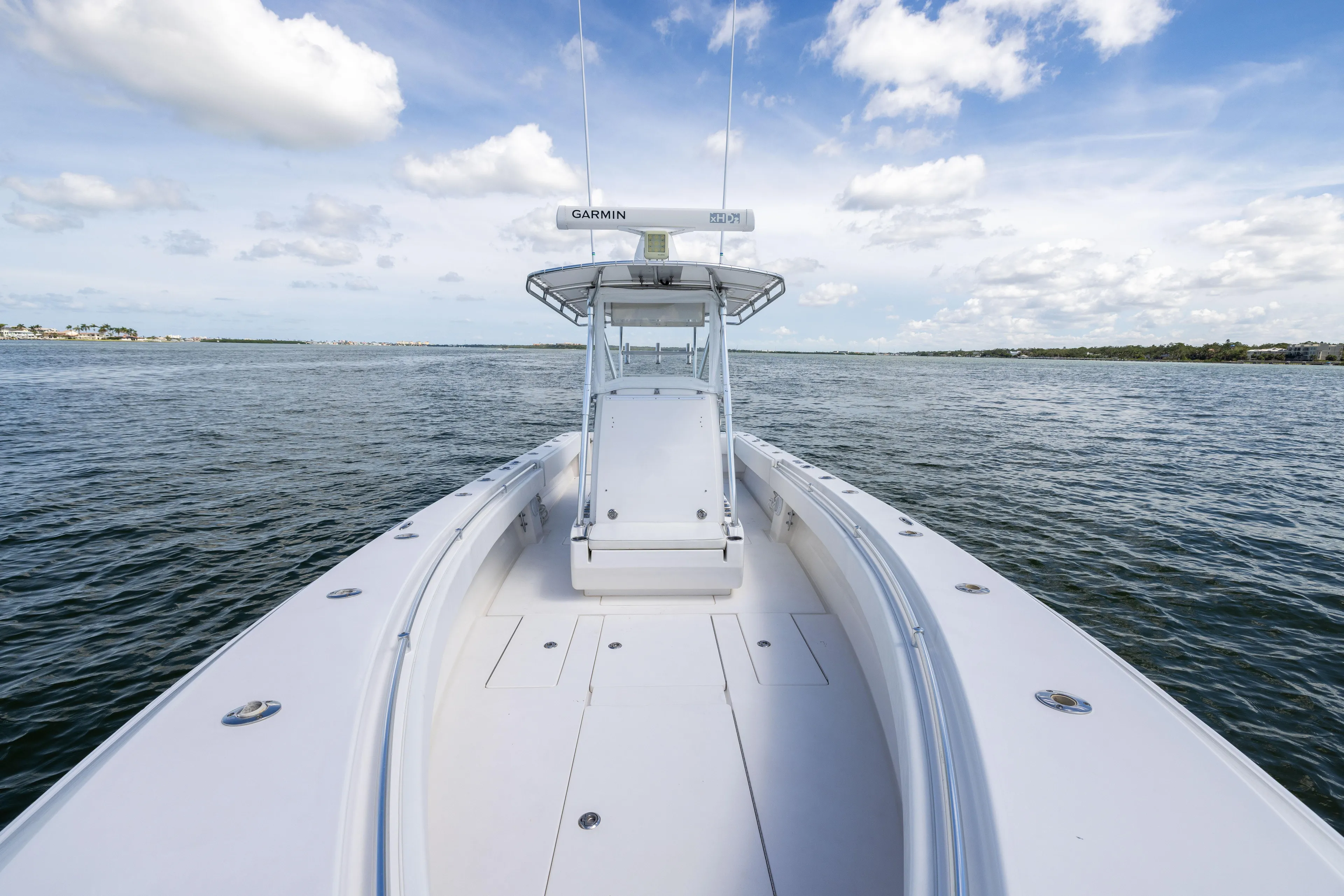  Yacht Photos Pics 2008 Contender 31 Open boat on calm water under a partly cloudy sky.