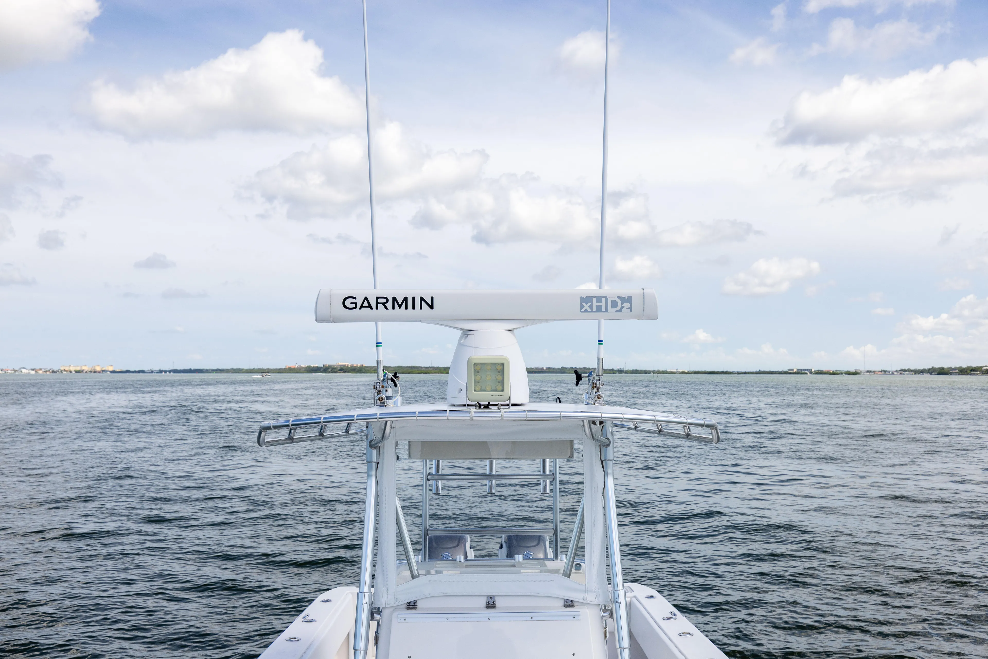  Yacht Photos Pics 2008 Contender 31 Open boat with Garmin radar on open water under cloudy sky.