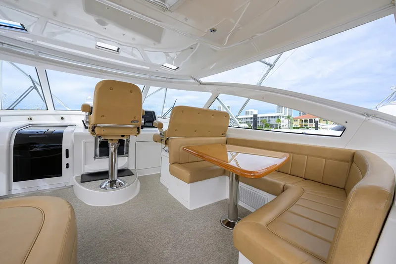  Yacht Photos Pics Luxurious interior of 2016 Viking 52 Open yacht with tan seating and helm.