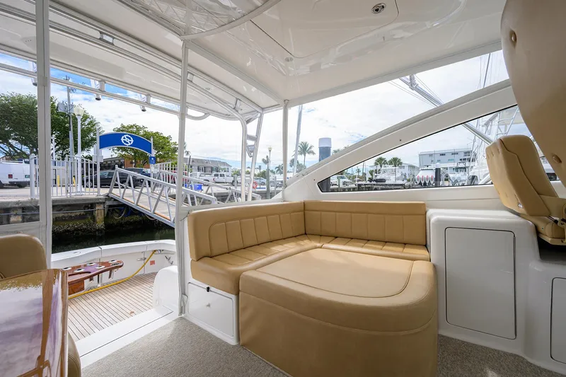  Yacht Photos Pics Interior of 2016 Viking 52 Open yacht with beige seating and marina view.