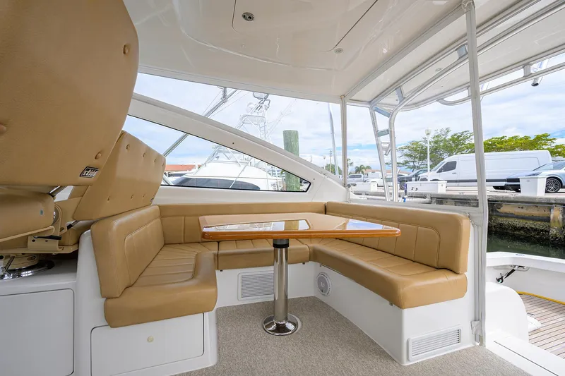  Yacht Photos Pics 2016 Viking 52 Open yacht interior with tan seating and wooden table.
