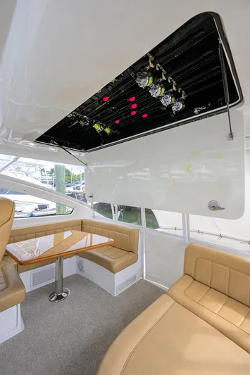  Yacht Photos Pics 2016 Viking 52 Open yacht interior with beige seating and wooden table.