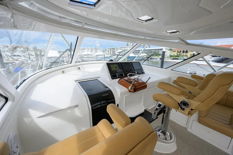  Yacht Photos Pics Luxurious helm of 2016 Viking 52 Open yacht with tan seating and advanced navigation systems.