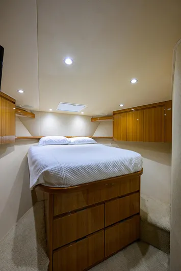  Yacht Photos Pics 2016 Viking 52 Open yacht bedroom with wood cabinetry and cozy lighting.