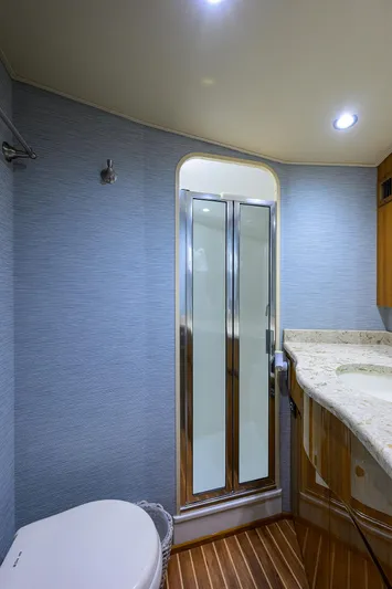  Yacht Photos Pics 2016 Viking 52 Open yacht bathroom with shower, toilet, and marble countertop.