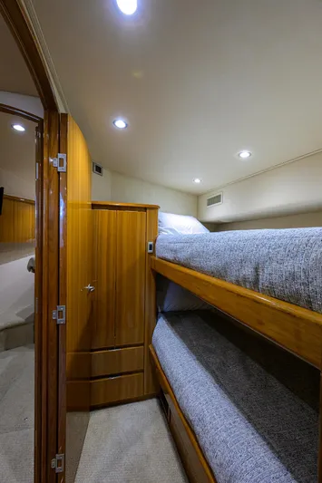  Yacht Photos Pics Interior of 2016 Viking 52 Open yacht with wooden bunk beds and soft lighting.