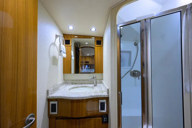  Yacht Photos Pics Luxurious bathroom in 2016 Viking 52 Open yacht with modern fixtures and wooden cabinetry.