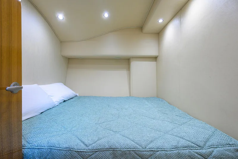  Yacht Photos Pics 2016 Viking 52 Open cabin interior with cozy bed and soft lighting.