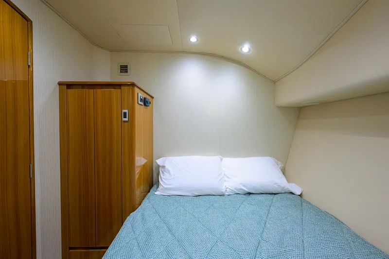  Yacht Photos Pics 2016 Viking 52 Open cabin interior with bed and wooden cabinetry.