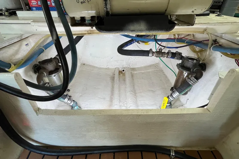 Next Yacht Photos Pics Engine compartment of a 1999 Post 42 Convertible boat, showing hoses and mechanical components.