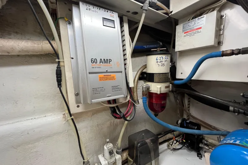 Next Yacht Photos Pics 1999 Post 42 Convertible engine room with 60 AMP battery charger and fuel filter system.