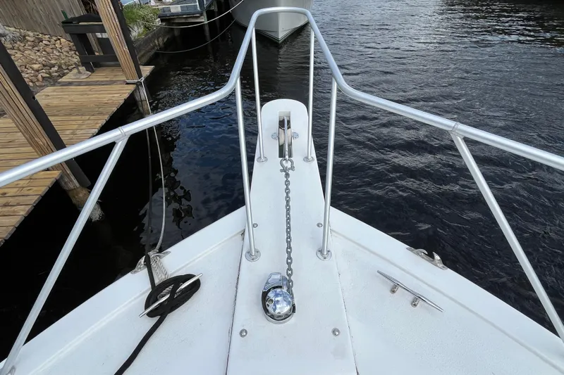Next Yacht Photos Pics Bow view of 1999 Post 42 Convertible boat docked by wooden pier.