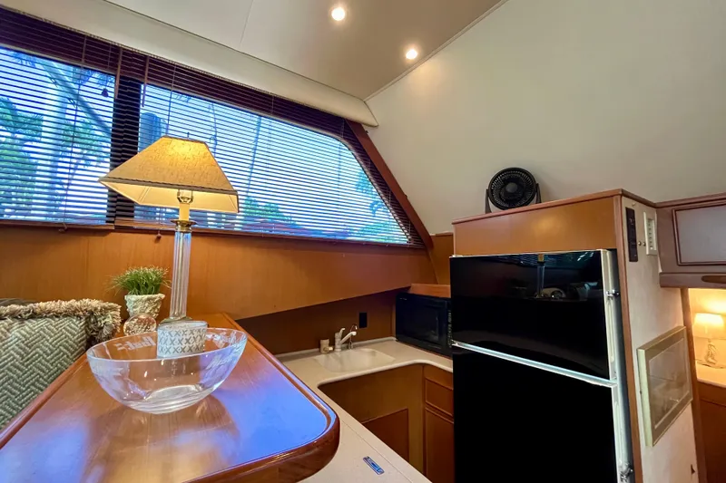 Next Yacht Photos Pics Interior of 1999 Post 42 Convertible yacht with kitchen, lamp, and window blinds.