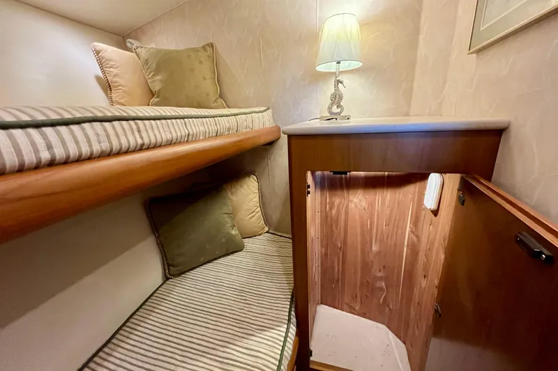 Next Yacht Photos Pics Cozy cabin interior of 1999 Post 42 Convertible yacht with bunk beds and lamp.