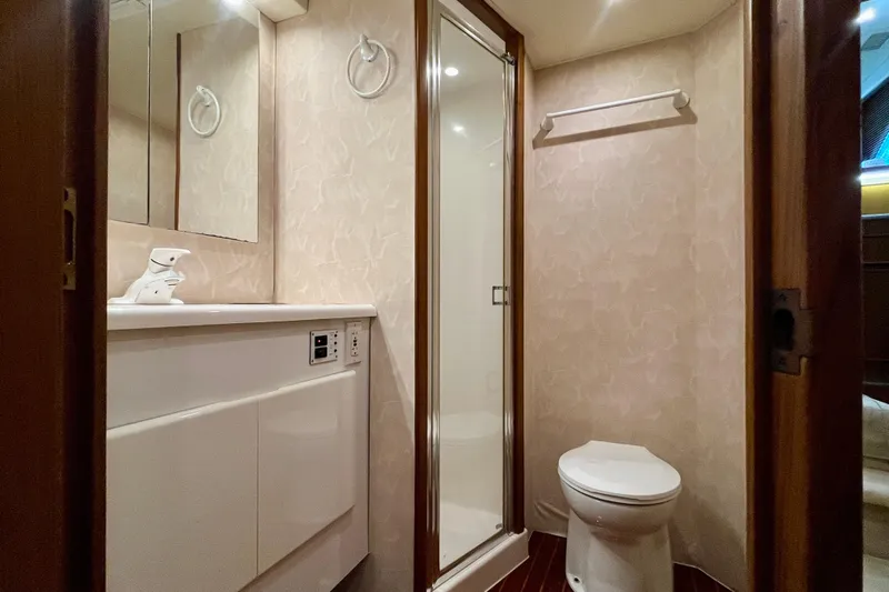 Next Yacht Photos Pics Bathroom interior of 1999 Post 42 Convertible yacht, featuring shower, toilet, and vanity.