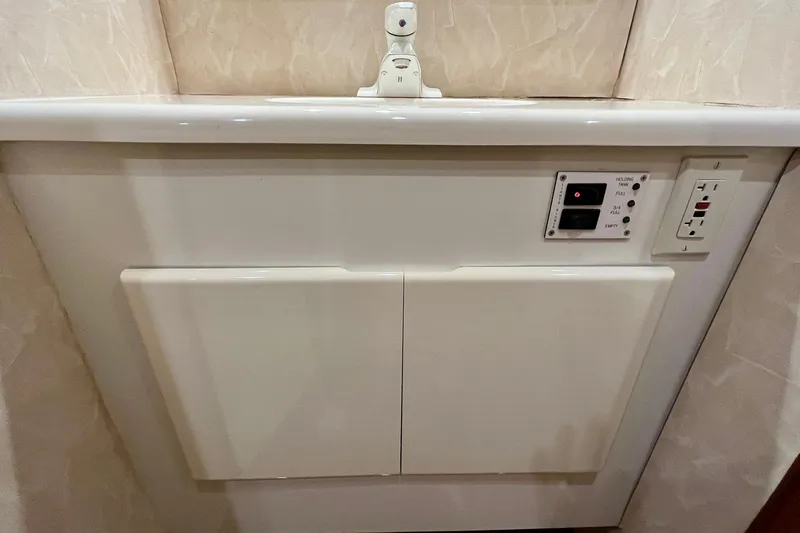 Next Yacht Photos Pics White bathroom sink with control panel and outlet, Post 42 Convertible, 1999 model.