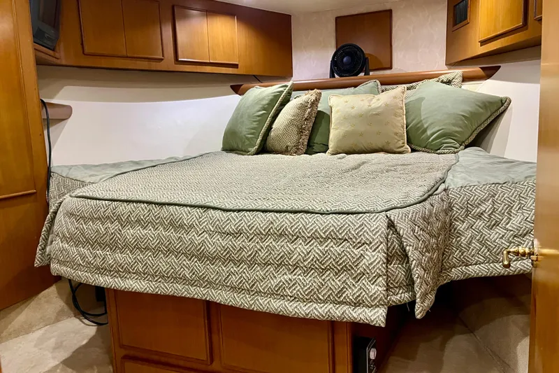 Next Yacht Photos Pics Luxurious cabin interior of 1999 Post 42 Convertible yacht with cozy bedding.