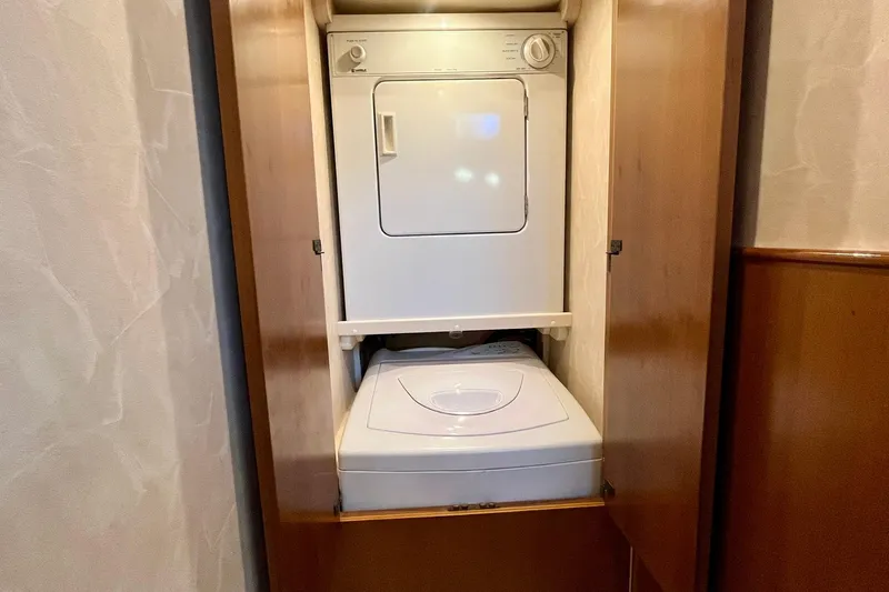 Next Yacht Photos Pics Stacked washer and dryer in wooden cabinet on 1999 Post 42 Convertible.