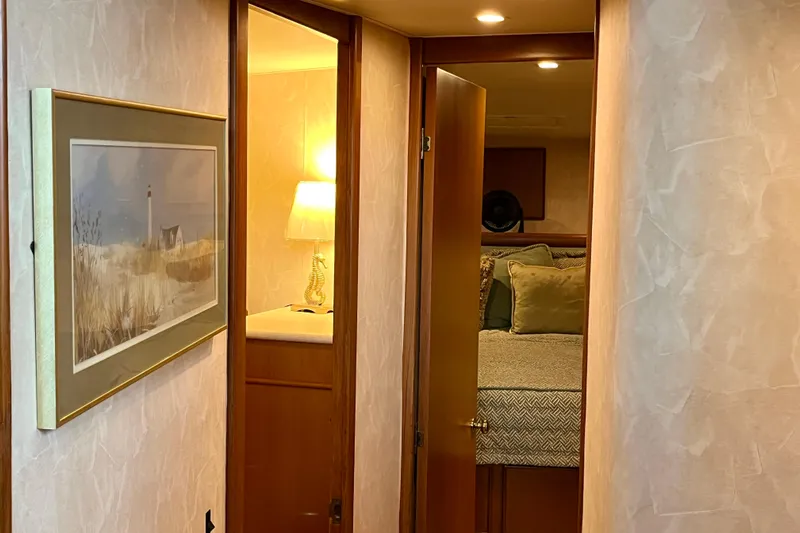 Next Yacht Photos Pics Interior of 1999 Post 42 Convertible yacht with cozy bedroom and nautical decor.