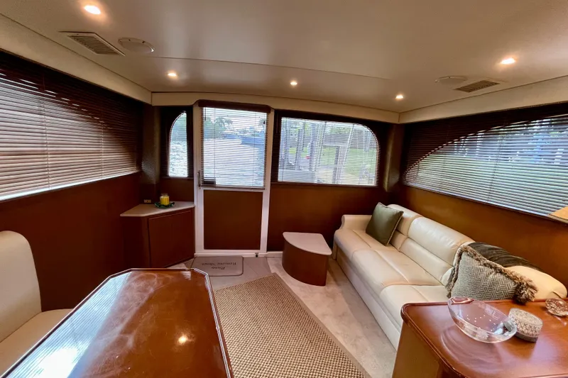 Next Yacht Photos Pics Luxurious interior of a 1999 Post 42 Convertible yacht with elegant seating and decor.