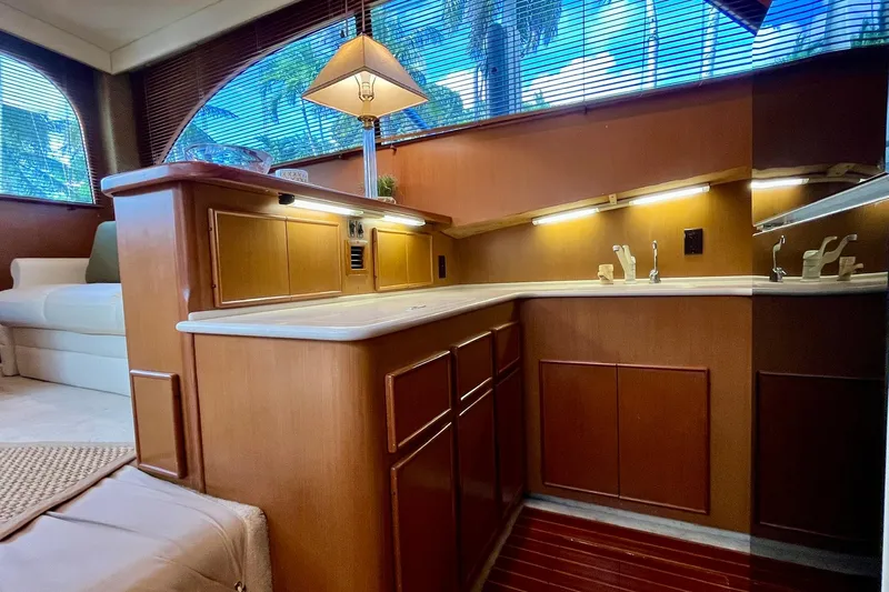 Next Yacht Photos Pics Luxurious interior of a 1999 Post 42 Convertible yacht with elegant wood cabinetry.