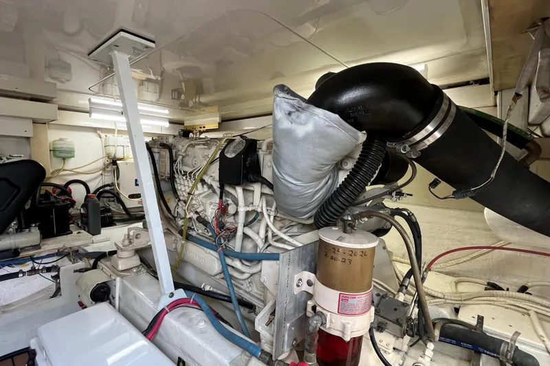 Next Yacht Photos Pics Engine room of a 1999 Post 42 Convertible boat, showcasing mechanical components and wiring.