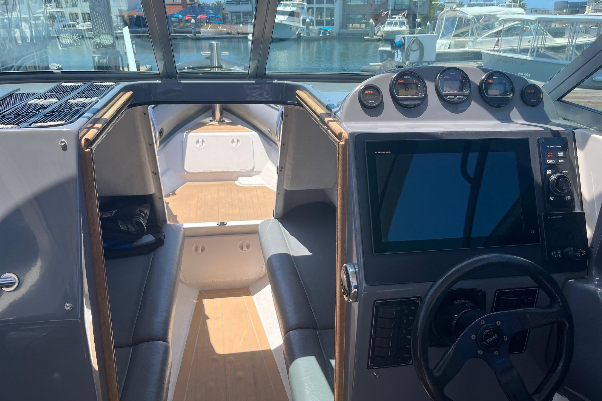 Interior view of a 2001 Protector Targa 28 boat with modern dashboard and seating.