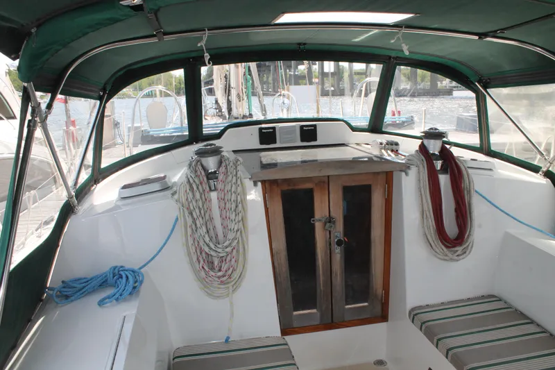 Callisto Yacht Photos Pics Cockpit of 2009 Outbound 46 sailboat with ropes and striped cushions.