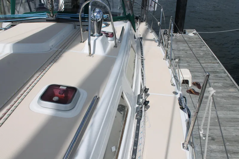 Callisto Yacht Photos Pics Outbound 46 sailboat deck, 2009 model, docked with visible hatch and railing.