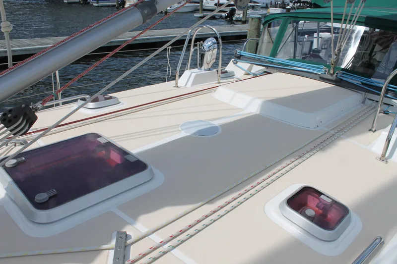 Callisto Yacht Photos Pics Sailboat deck of 2009 Outbound 46 with hatches and rigging in a marina setting.