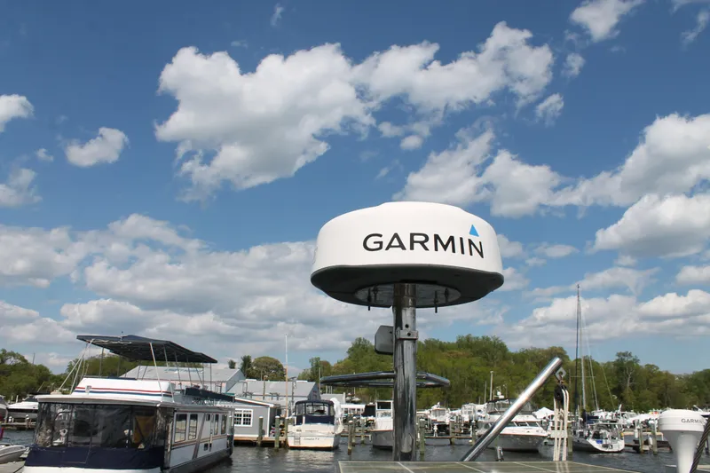 Callisto Yacht Photos Pics Marina with boats and Garmin radar, Outbound 46, 2009 model, under a blue sky.