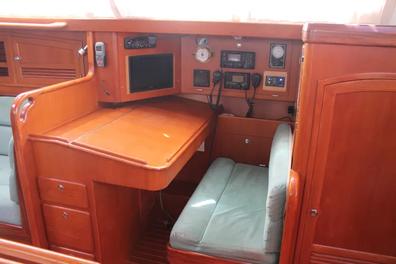 Callisto Yacht Photos Pics Navigation station in 2009 Outbound 46 yacht with wooden cabinetry and communication equipment.