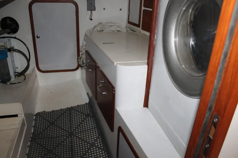 Callisto Yacht Photos Pics Interior of 2009 Outbound 46 yacht, featuring storage cabinets and nautical equipment.