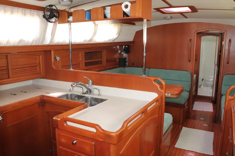 Callisto Yacht Photos Pics Luxurious 2009 Outbound 46 yacht interior with wooden cabinetry and modern kitchen amenities.