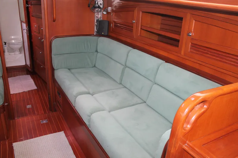 Callisto Yacht Photos Pics Luxurious interior of 2009 Outbound 46 yacht with plush seating and wooden finishes.