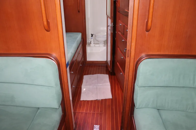 Callisto Yacht Photos Pics Interior of 2009 Outbound 46 yacht with wooden finish and green seating.