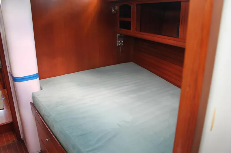 Callisto Yacht Photos Pics Cozy cabin interior of 2009 Outbound 46 yacht with wooden finish and comfortable bed.
