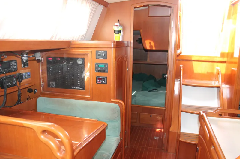 Callisto Yacht Photos Pics Interior of 2009 Outbound 46 yacht with wood finish and navigation equipment.
