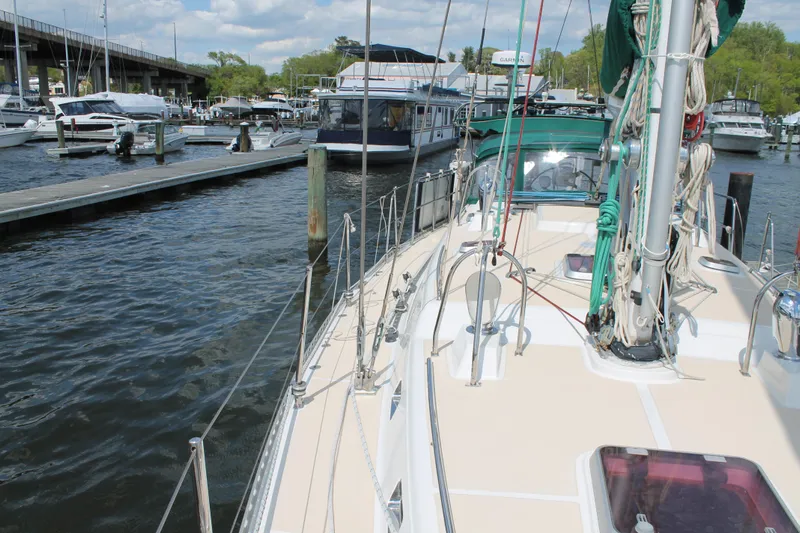 Callisto Yacht Photos Pics Sailboat docked at marina, Outbound 46 model, 2009, with clear skies and calm waters.