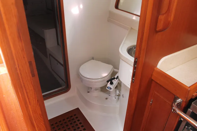 Callisto Yacht Photos Pics Compact bathroom in 2009 Outbound 46 yacht with wooden cabinetry and modern fixtures.
