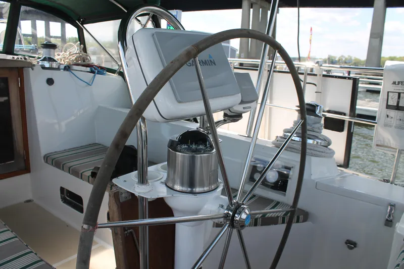 Callisto Yacht Photos Pics Steering wheel of a 2009 Outbound 46 sailboat with navigation equipment.