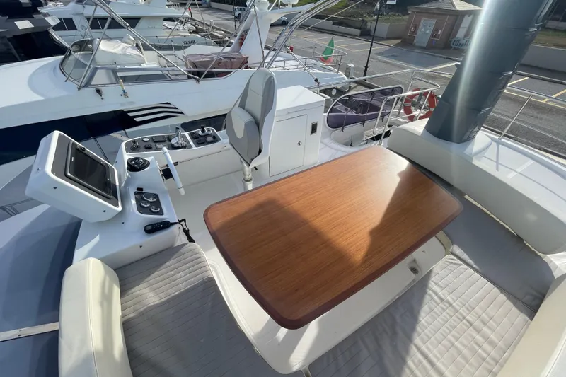 Boa Sorte Yacht Photos Pics Flybridge of 2017 Azimut Magellano 53 yacht with helm station and wooden table.
