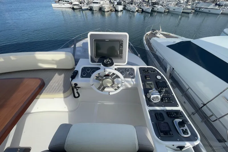 Boa Sorte Yacht Photos Pics Flybridge helm of 2017 Azimut Magellano 53 yacht, featuring navigation controls and steering wheel.