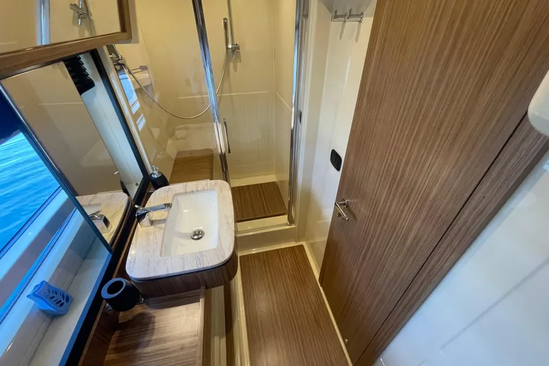 Boa Sorte Yacht Photos Pics Luxurious bathroom interior of 2017 Azimut Magellano 53 yacht with modern fixtures.