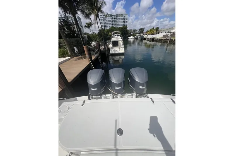  Yacht Photos Pics 2014 Stamas 390 Tarpon with triple 300 horsepower engines docked by palm trees.