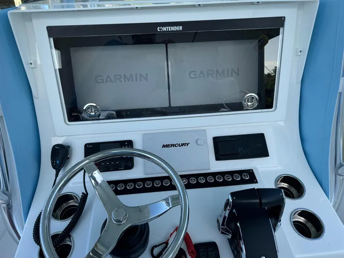  Yacht Photos Pics 2024 Contender 32 ST boat dashboard with Garmin displays and Mercury controls.