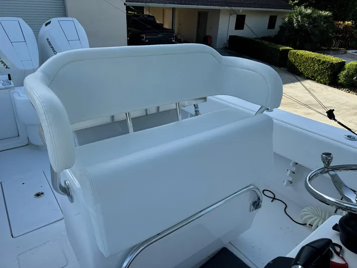  Yacht Photos Pics 2024 Contender 32 ST boat with white seating and steering wheel.