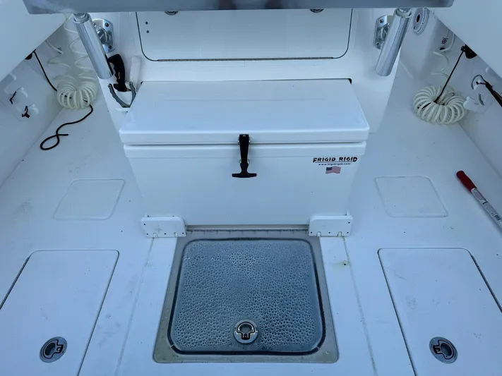  Yacht Photos Pics 2024 Contender 32 ST boat deck with storage compartments and cooler.