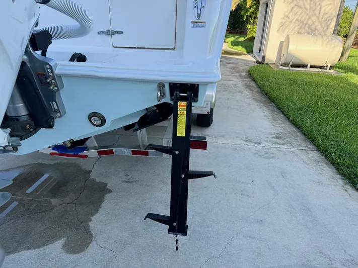  Yacht Photos Pics 2024 Contender 32 ST boat trailer with support jack on concrete driveway.